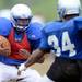 Lincoln football players run a drill during a practice at the school on Thursday. Melanie Maxwell I AnnArbor.com
